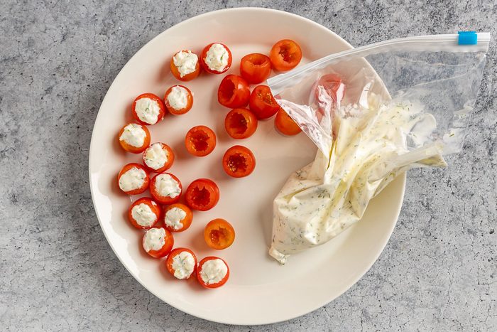 Taste of Home Stuffed Cherry Tomatoes photo filling the tomatoes.
