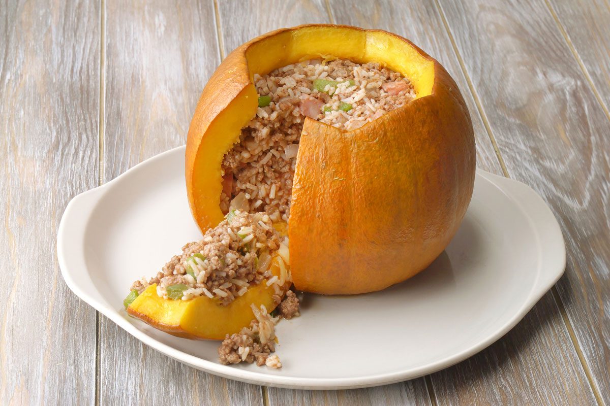 Finished stuffed pumpkin on a plate with a slice cut