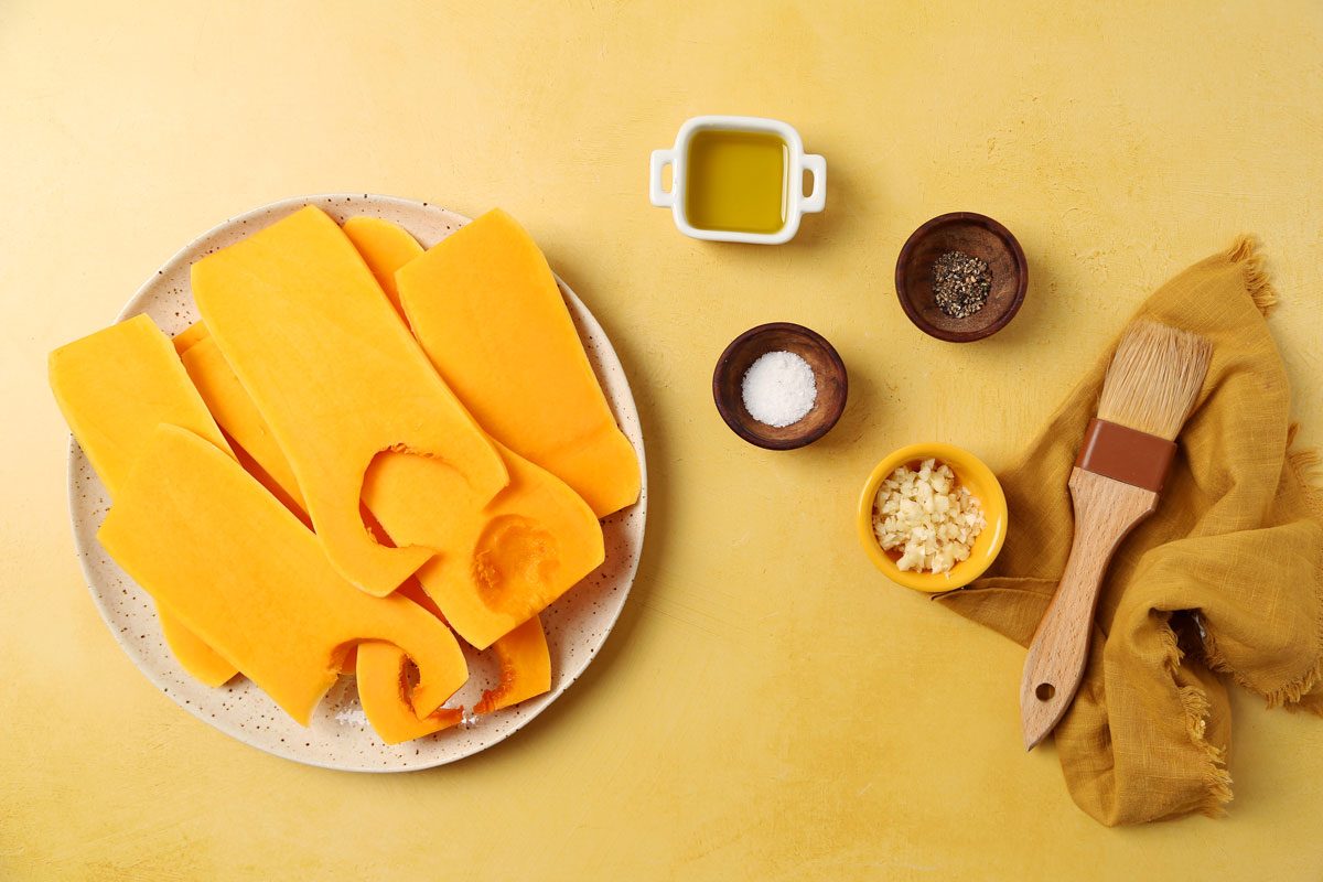 Process of making Taste of Home's Grilled Squash grilled butternut squash on a platter on a bright yellow surface.
