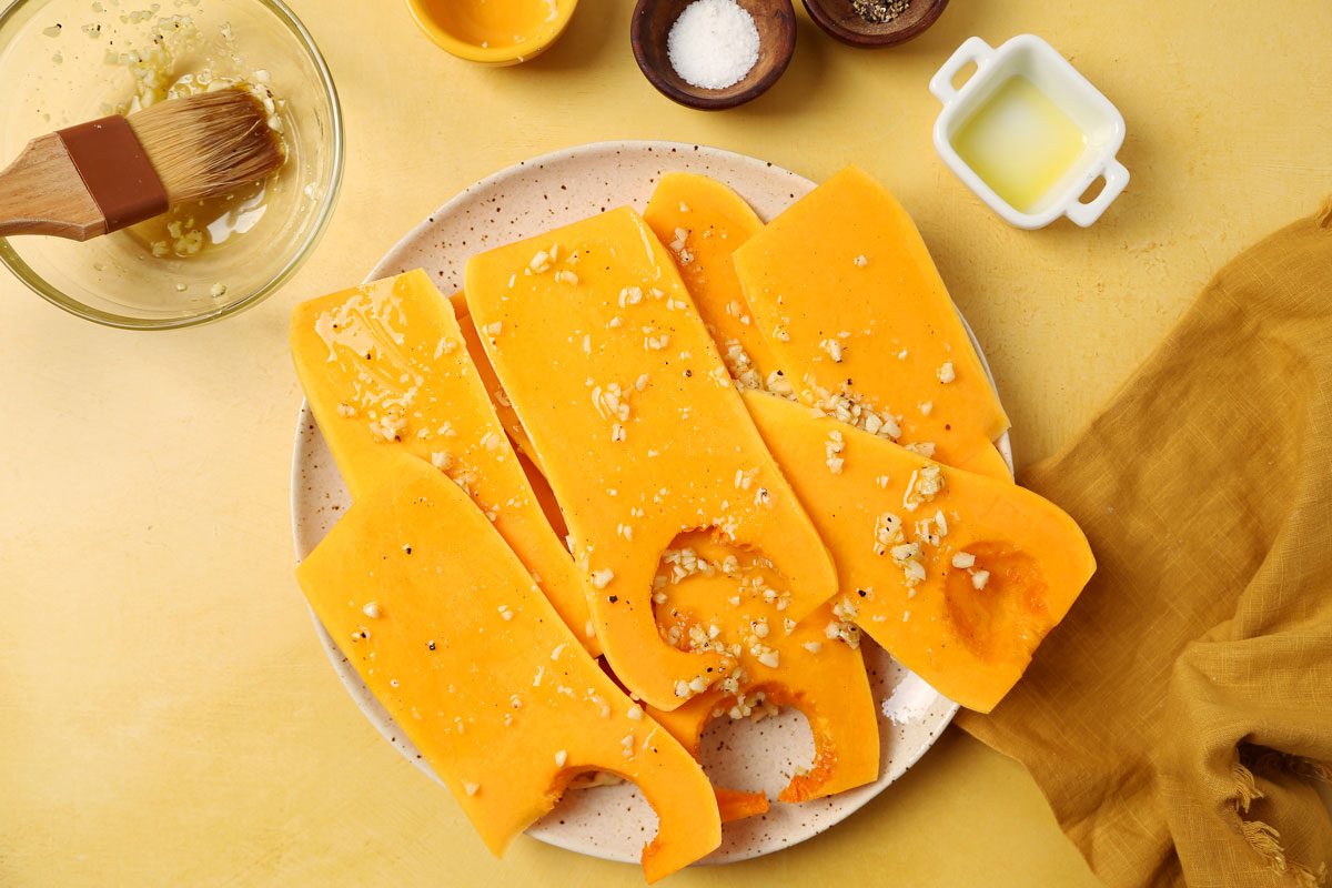 Process of making Taste of Home's Grilled Squash grilled butternut squash on a platter on a bright yellow surface.