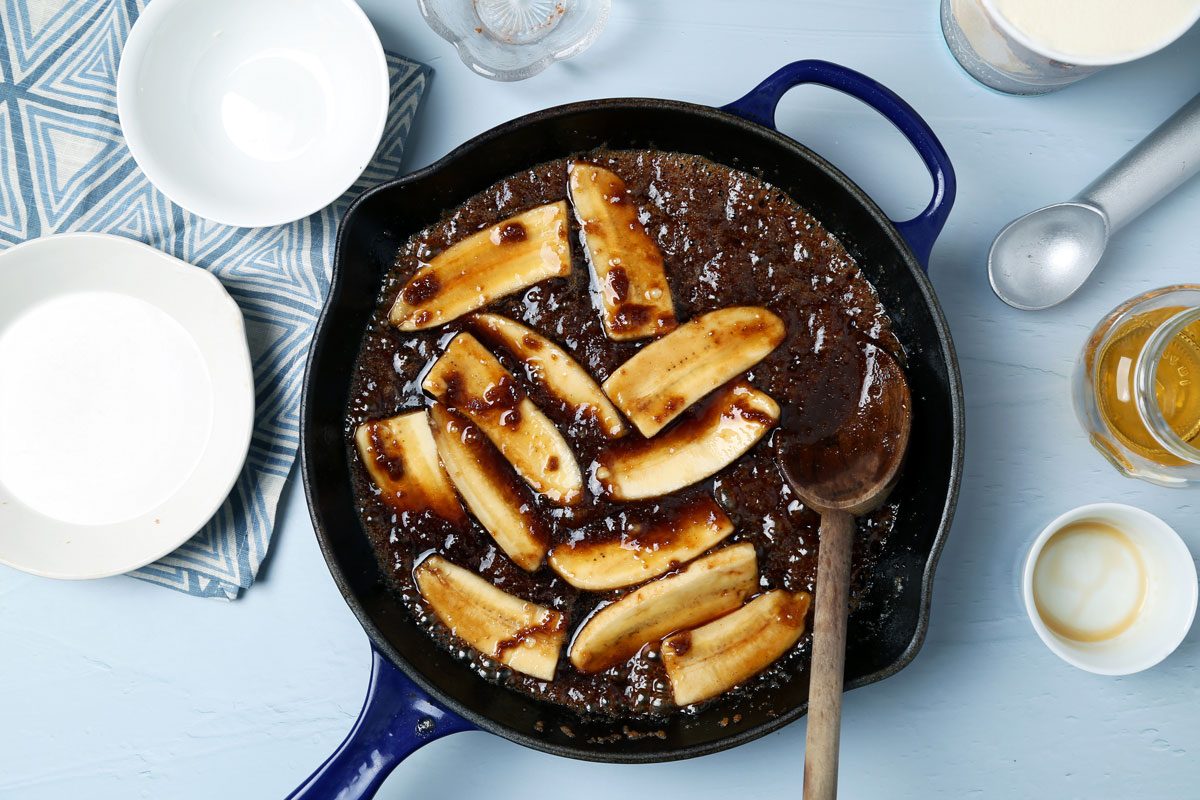 Process of making Taste of Home's bananas foster laid out on a light blue surface with a blue linen.