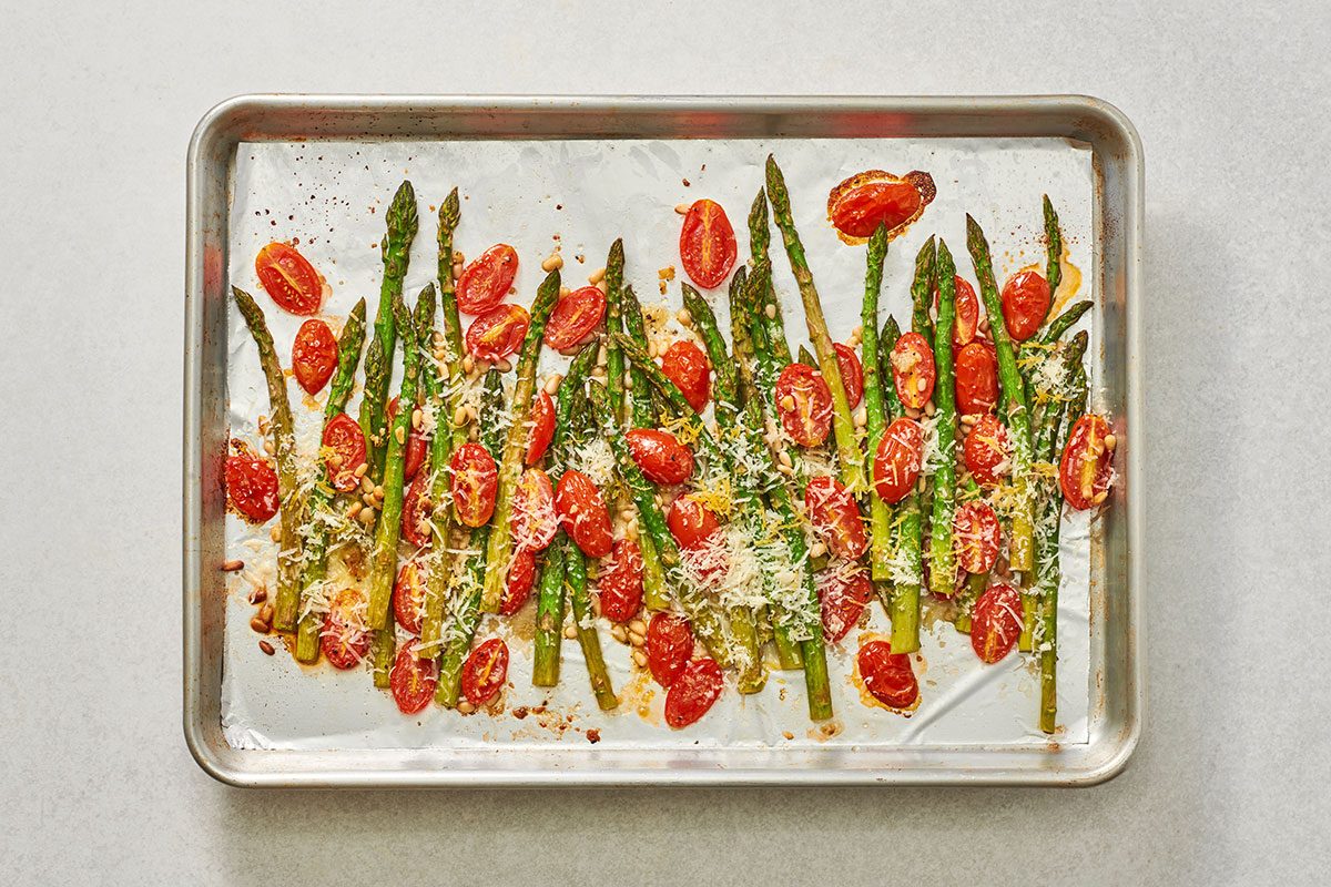 Baked asparagus and tomatoes, sprinkled with Parmesan and lemon zest
