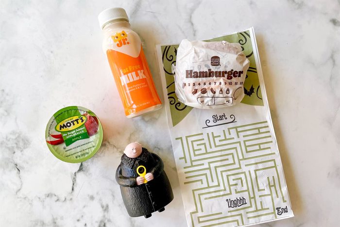 Burger King Fast Food Kids Meal items arranged on marble kitchen counter