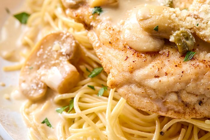 Close shot of Cheesecake Factorys Chicken Piccata; serve on plates.