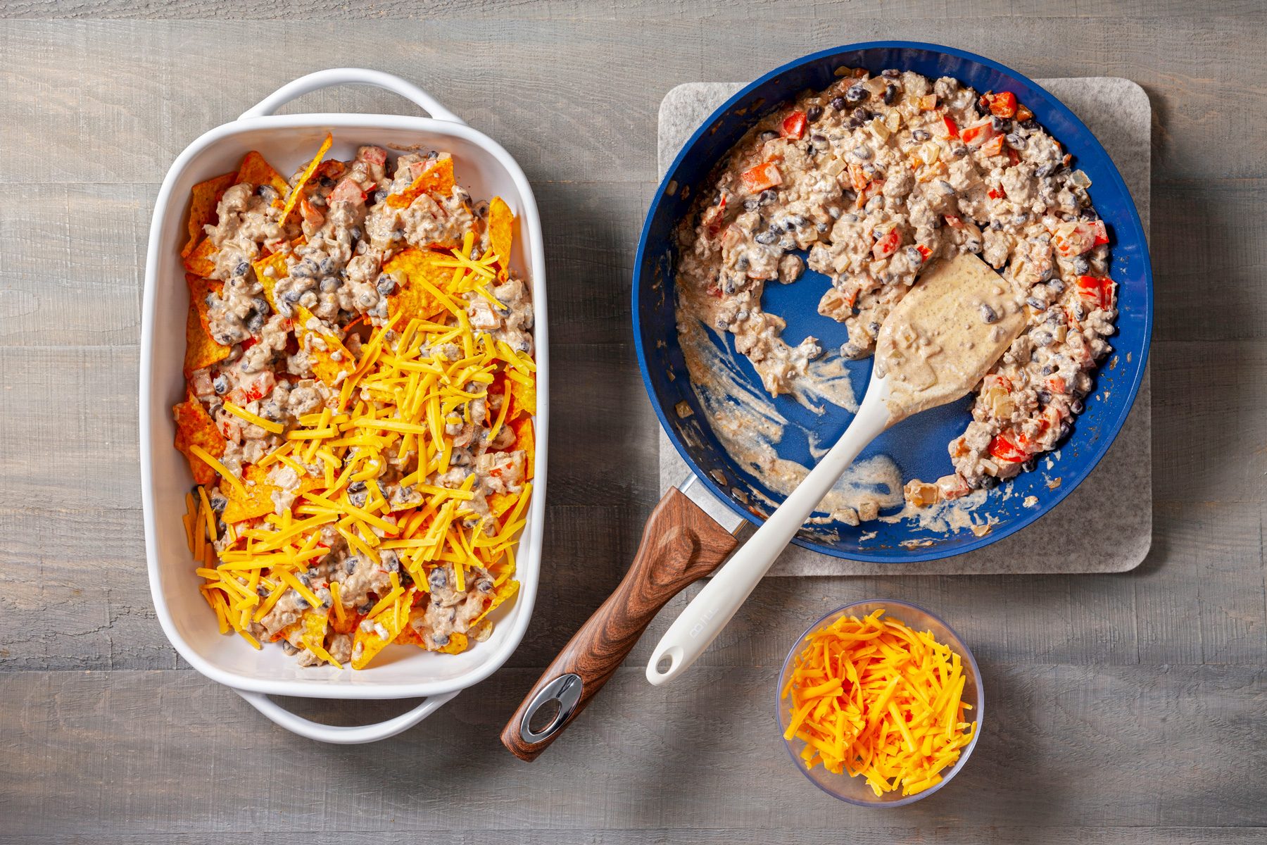 In a greased baking dish, layer half of the Doritos, half of the meat mixture, and cheddar cheese; then repeat the layers.