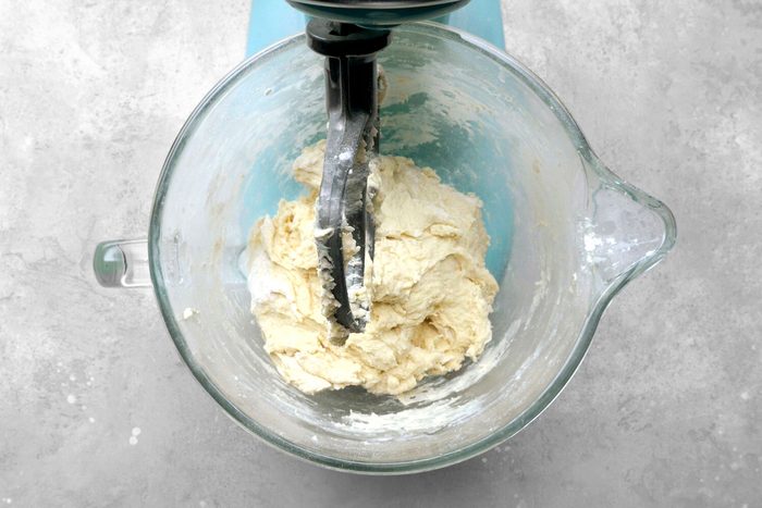 Dough being mixed in a large bowl.