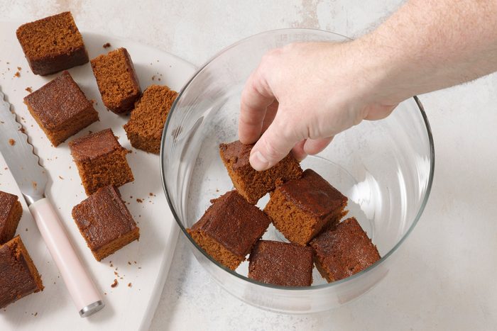 Overhead shot of prepare cake mix batter according to package directions; bake as directed in two square pans; cool as package directs; cut into cubes; marble surface.