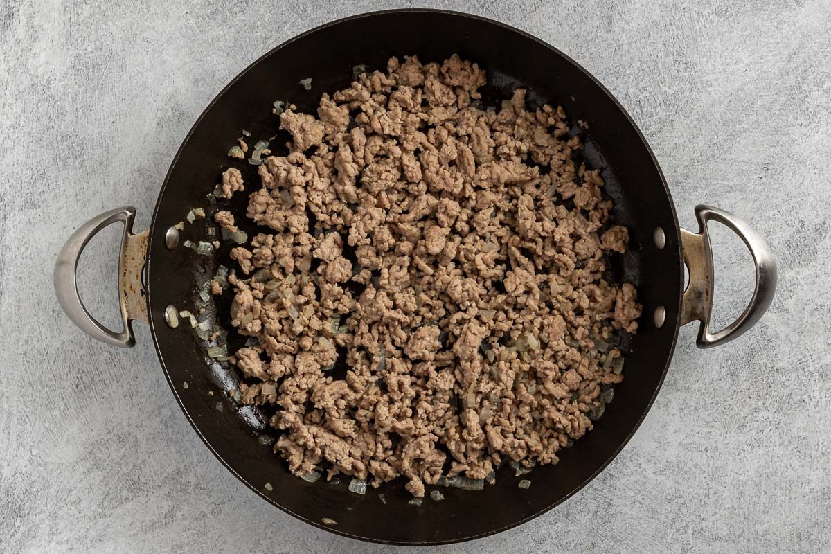 Taste of Home Ground Pork Pasta recipe photo of the cooked ground pork and onion in a skillet.