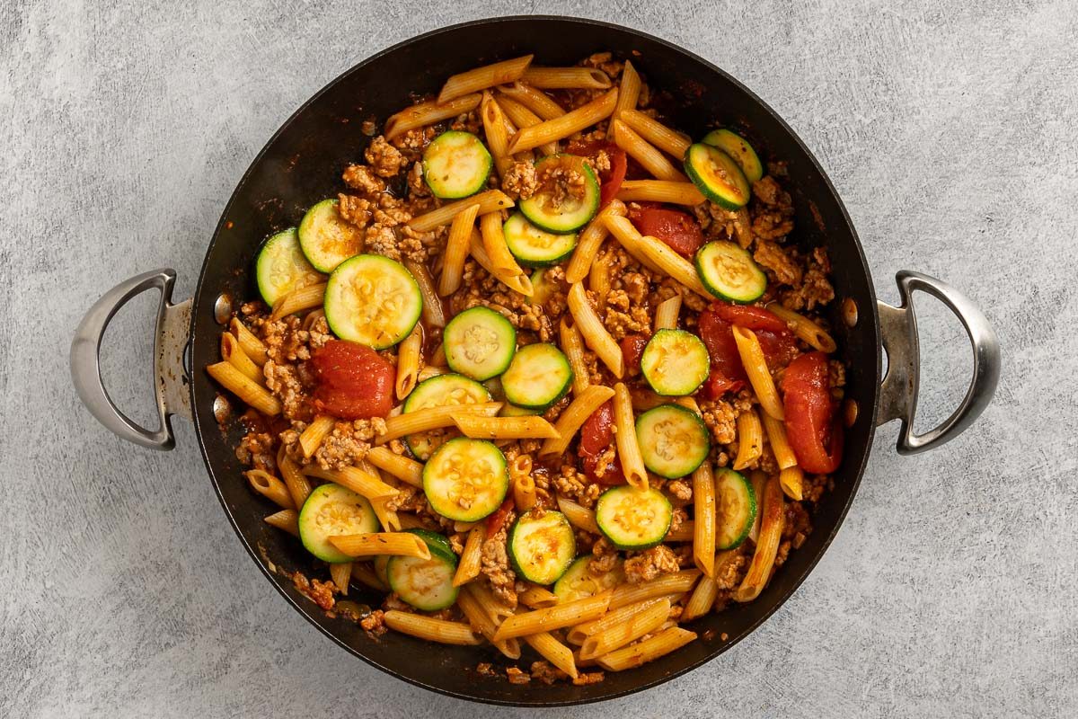 Taste of Home Ground Pork Pasta recipe photo of the pasta and zucchini added to the skillet.
