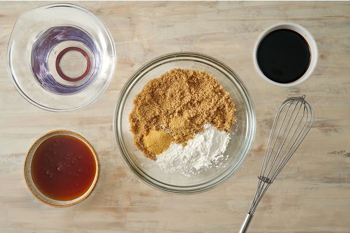 Overhead view of brown sugar, cornstarch, garlic powder, ginger, honey, soy sauce, and water to create the honey garlic sauce for the Taste of Home Honey Garlic Ribs recipe.