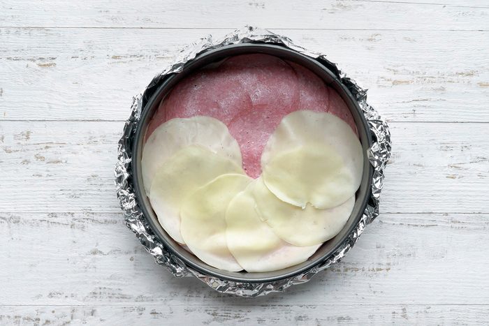 Press together to form a circle and seal seams; place over filling.