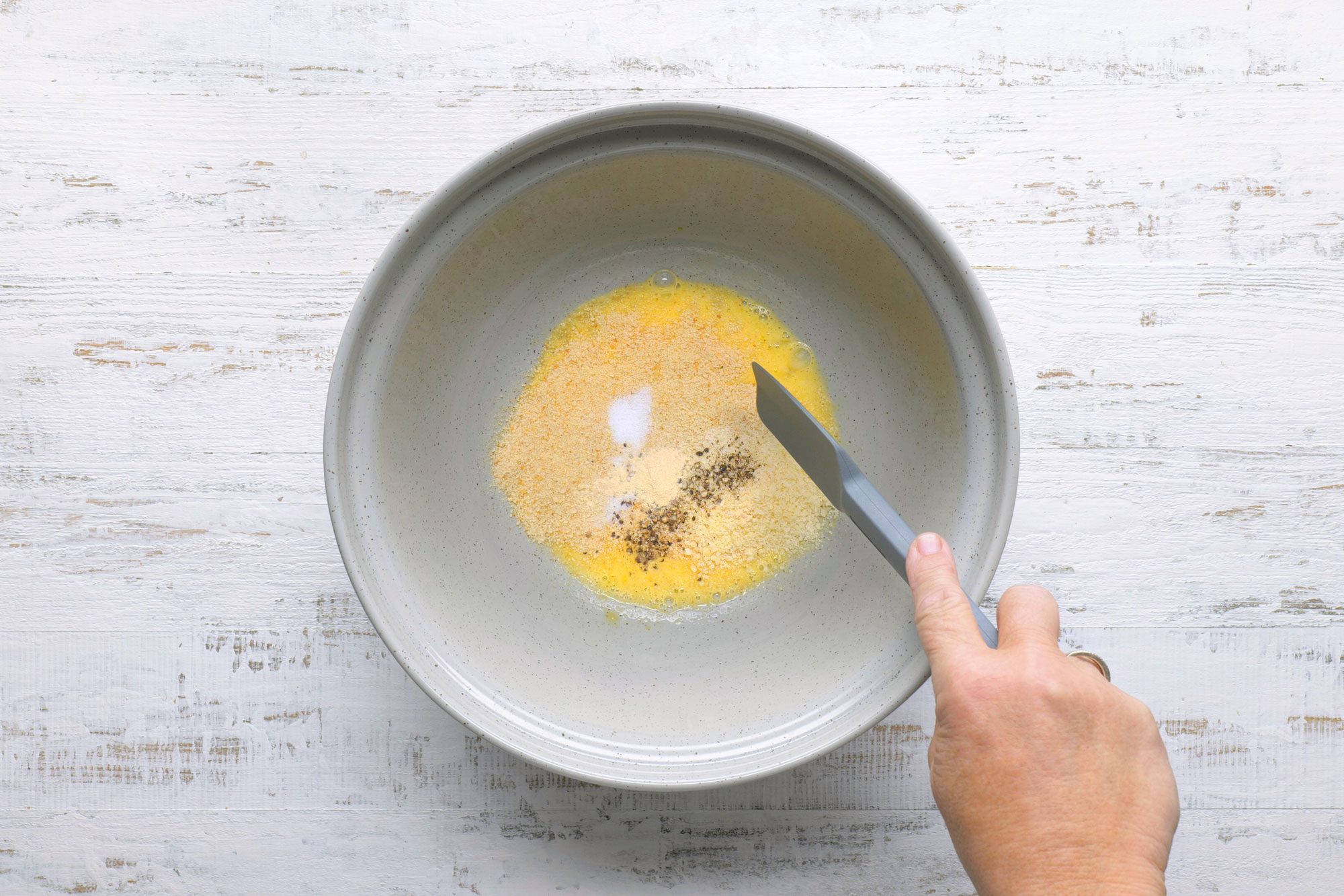 Add the bread crumbs, cheese, salt, pepper and garlic powder and mix it with spatula