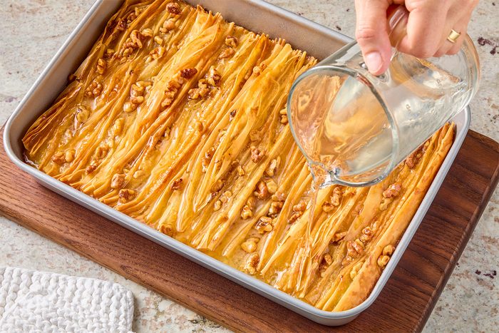 Drizzle simple syrup over warm cake.