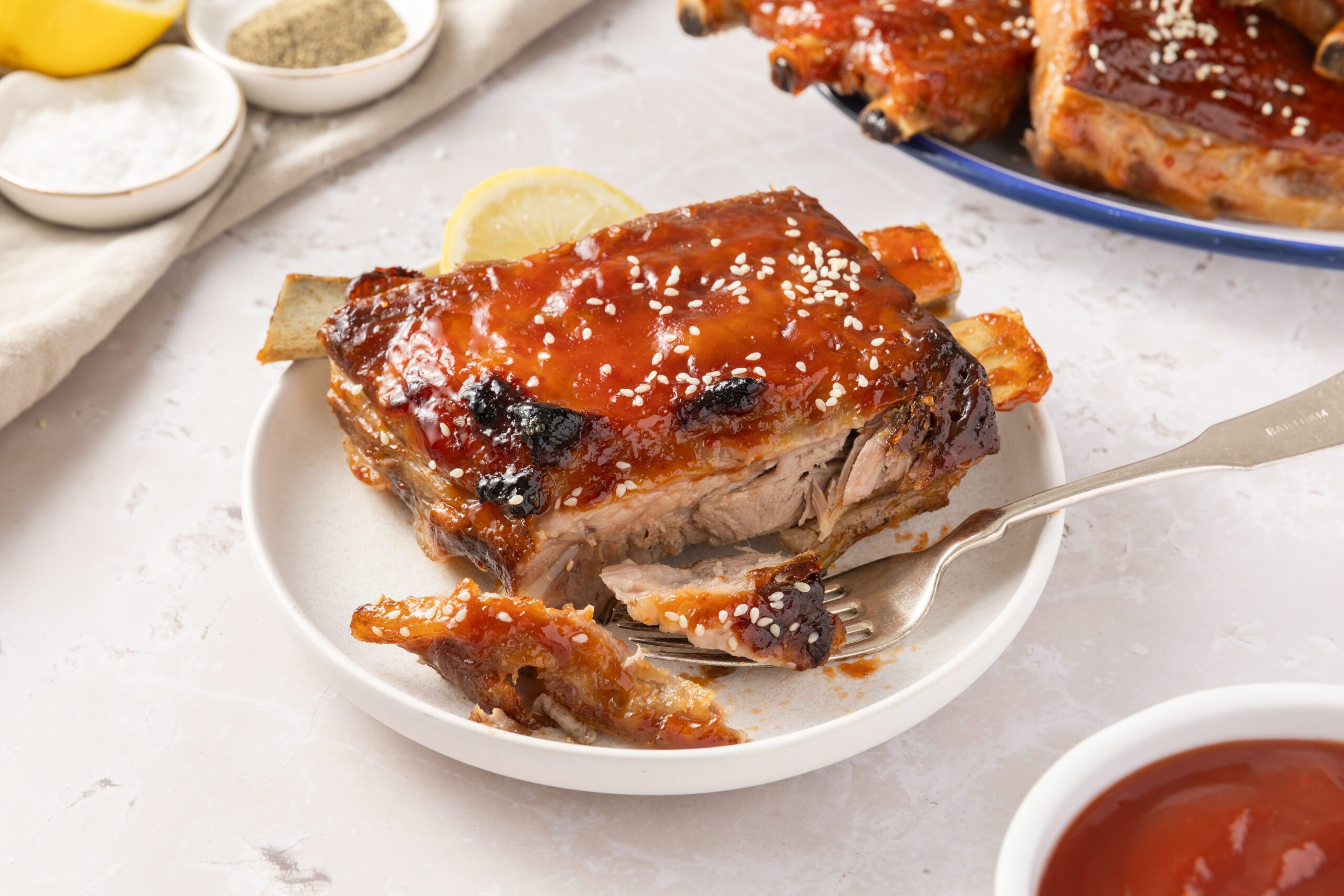 Detail of sweet and sour spareribs on a fork.