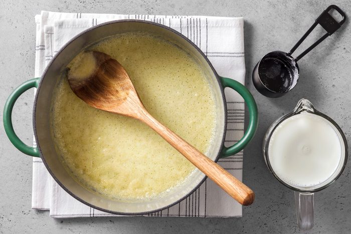 Butter and flour in a large saucepot with a wooden ladle