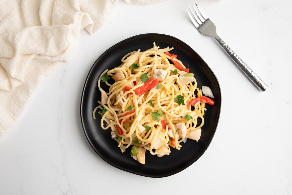 Beauty shot for Taste of Home Turkey Tetrazzini with Cream of Mushroom Soup, being served on a black plate.