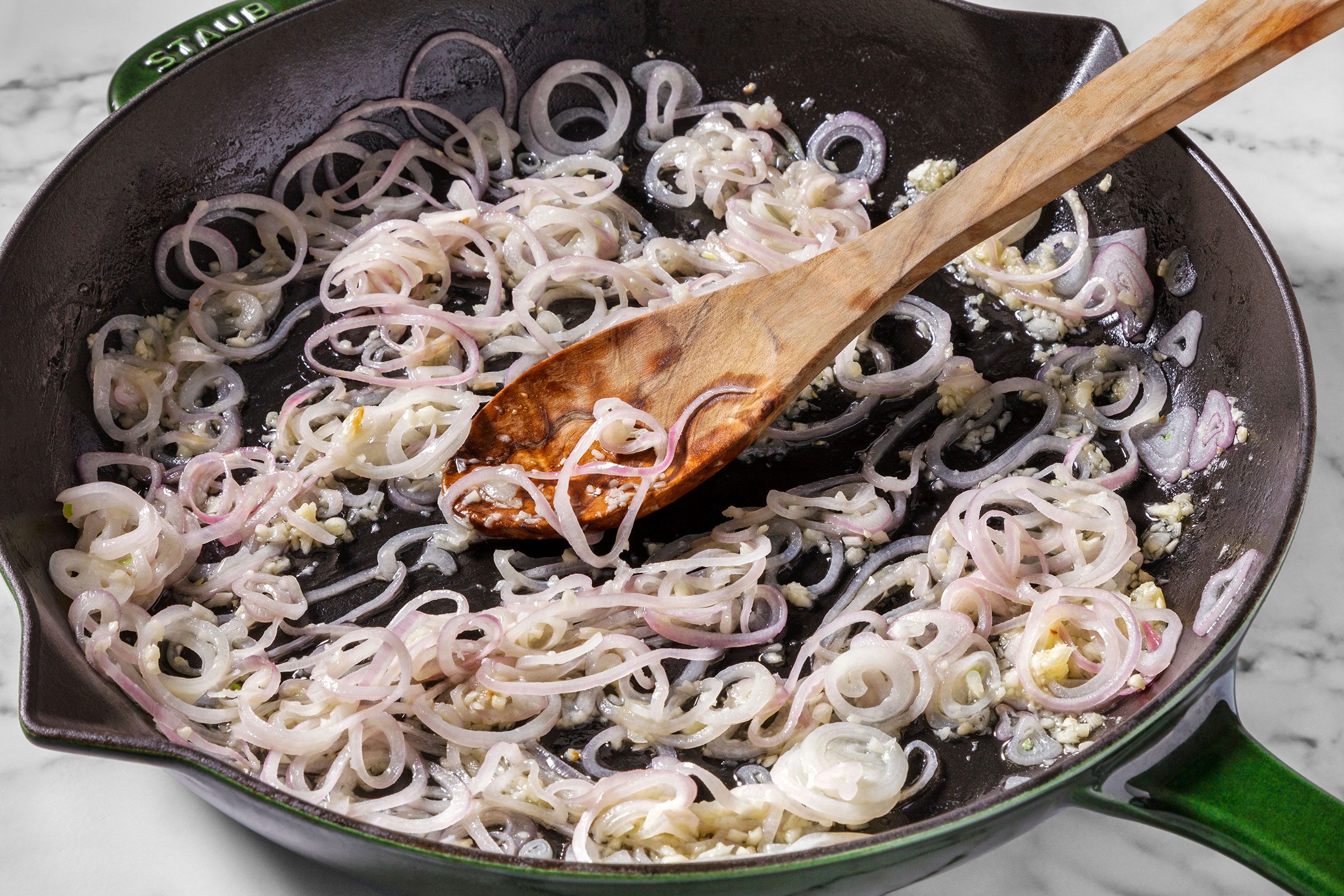 Shallots and garlic heated in oil in a large skillet