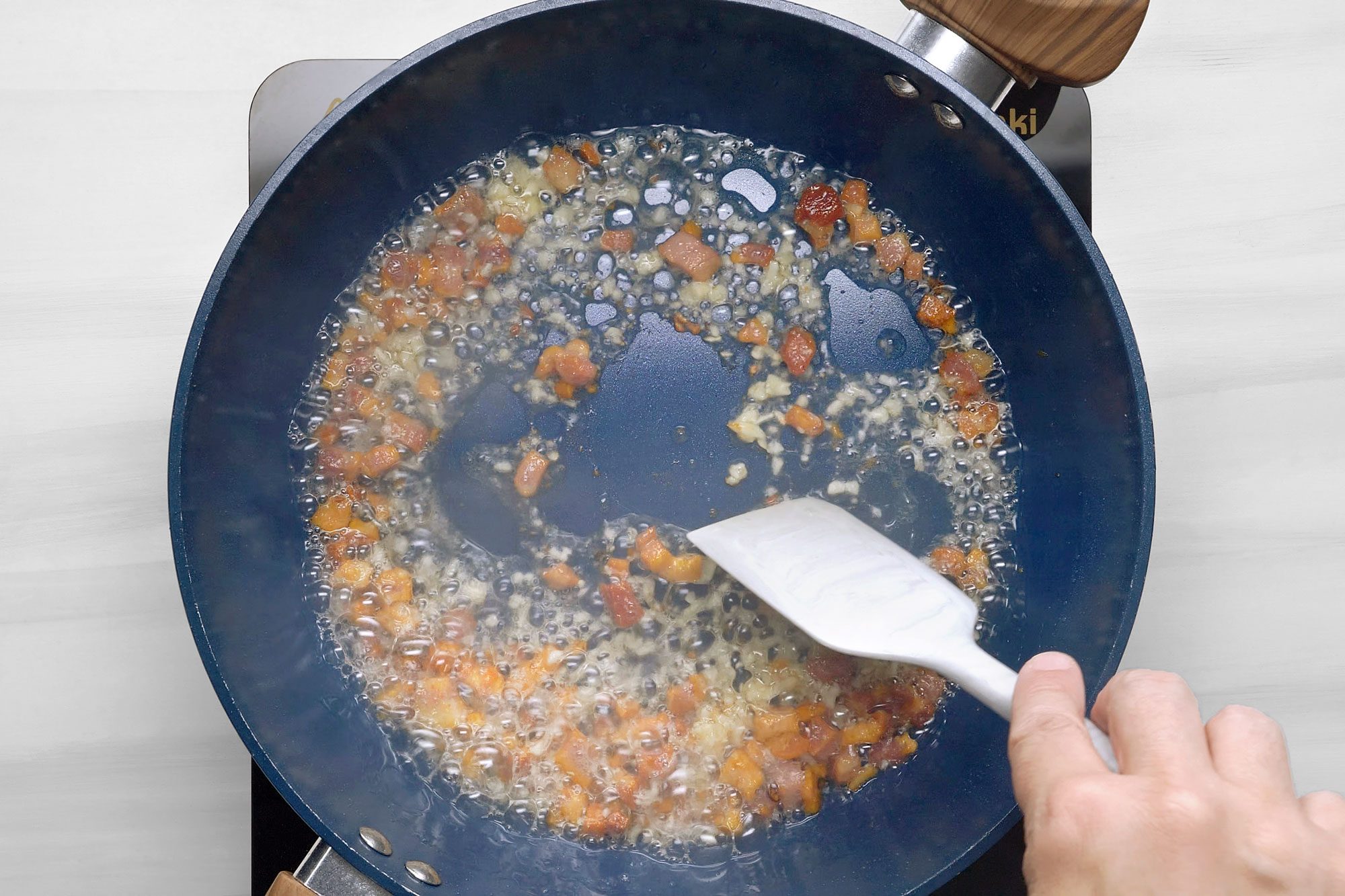 In a large skillet, heat oil over medium heat. Add pancetta, cook and stir until crispy
