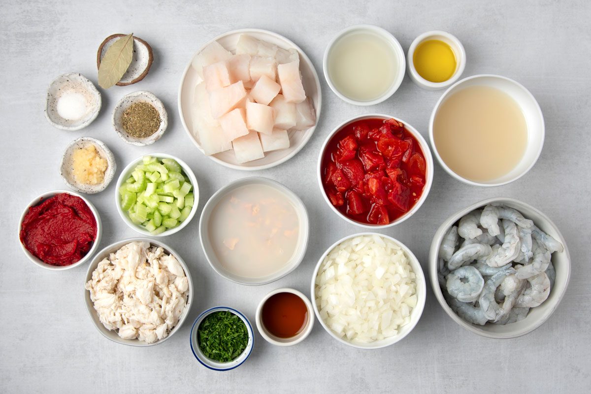 overhead shot of Cioppino's ingredients placed over white background