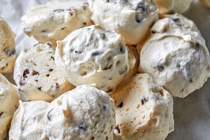 A close-up of Forgotten Cookies reveals their chocolate chip meringue magic, boasting a light, airy texture.