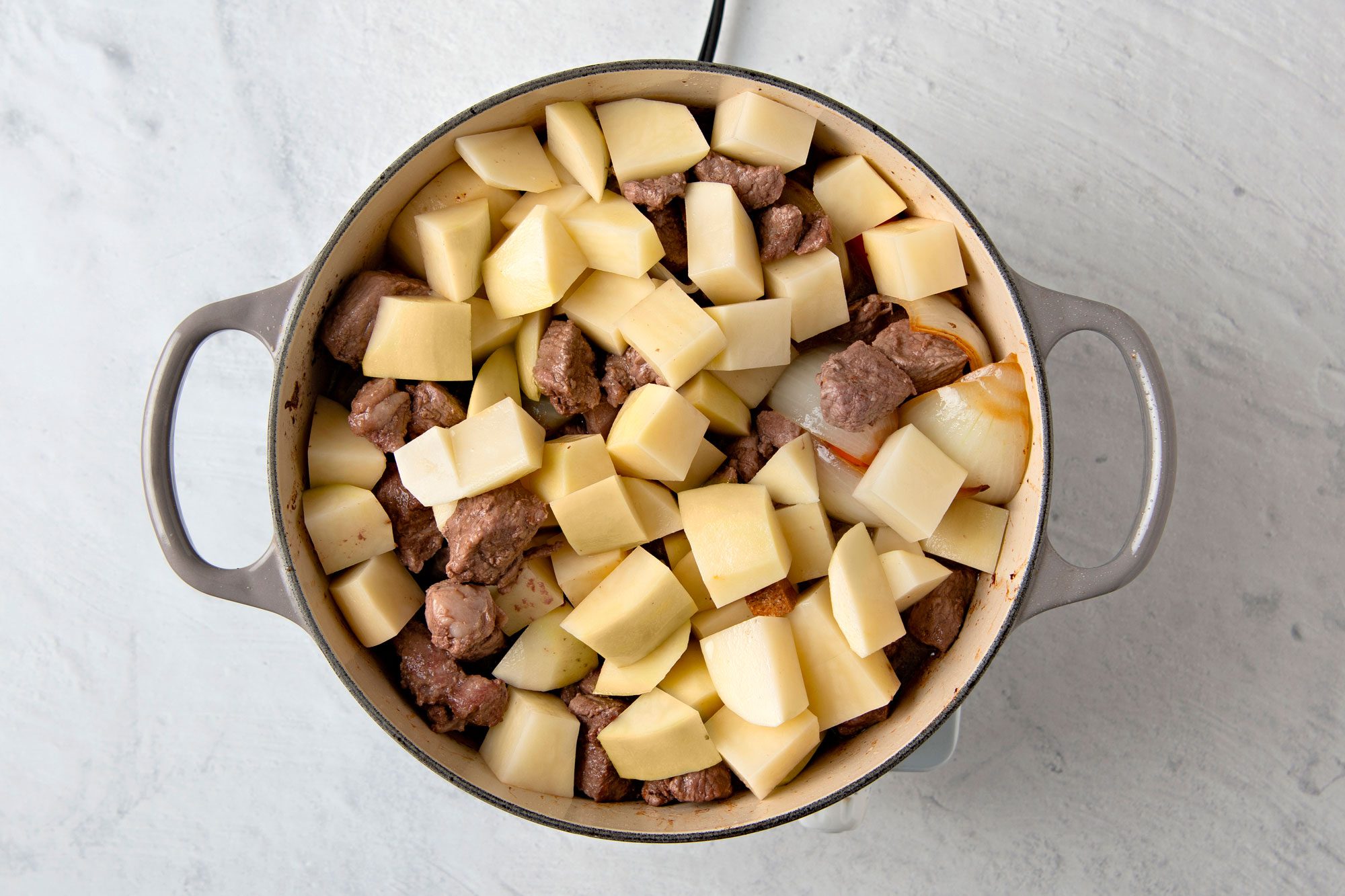 Add potatoes, broth, salt, pepper and lamb; bring to a boil