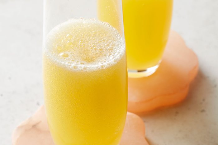 Close shot of Mimosa; served in glasses; coaster; marble background;