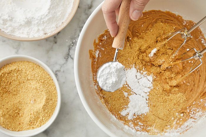 Gradually beat in confectioners' sugar and cracker crumbs.