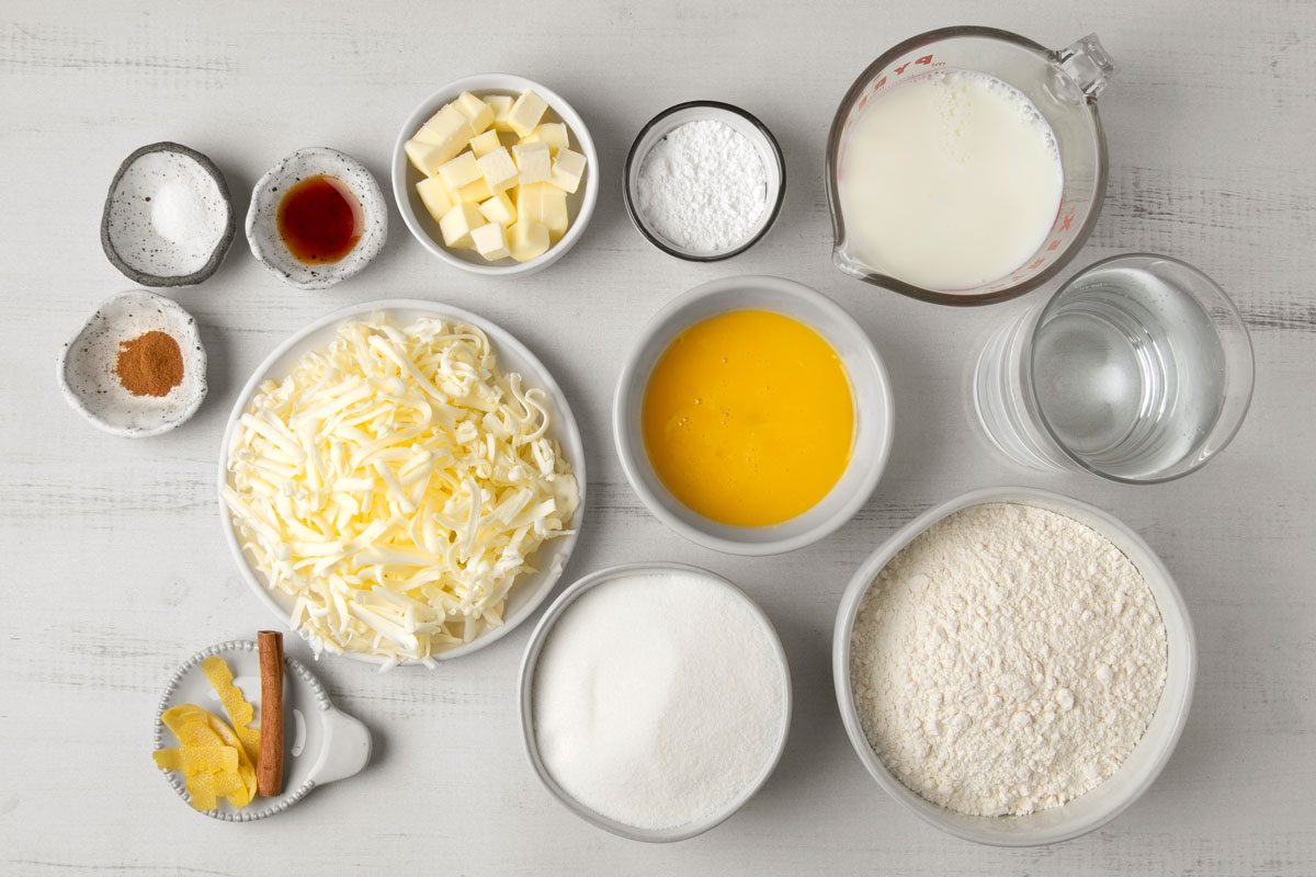overhead shot of Portuguese Egg Tarts ingredients placed over grey background;