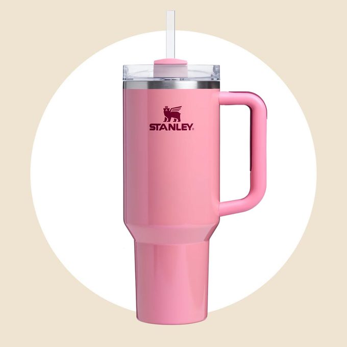 Light magenta Stanley tumbler on a white and tan background