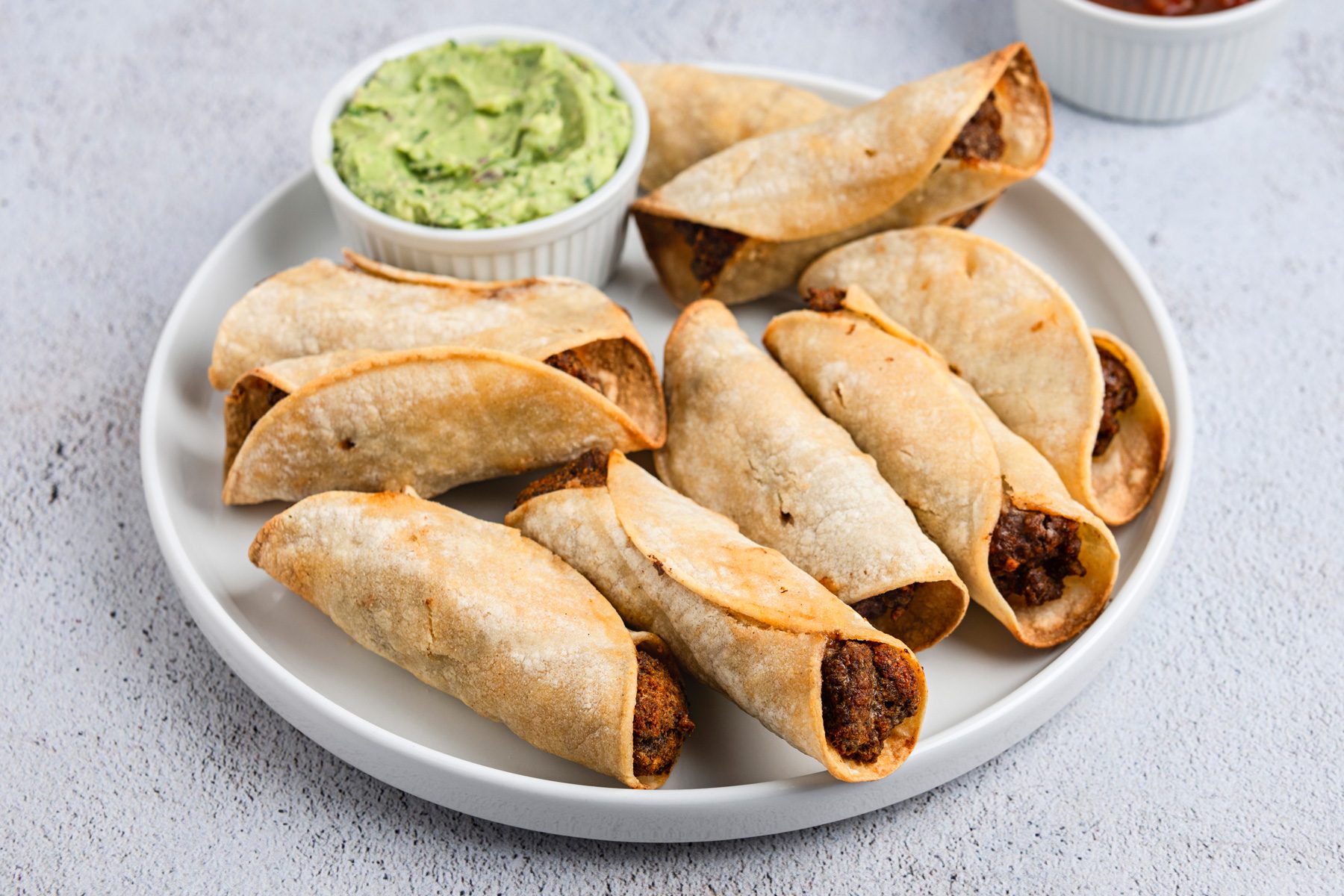 Air Fryer Taquitos is ready and served in a plate.