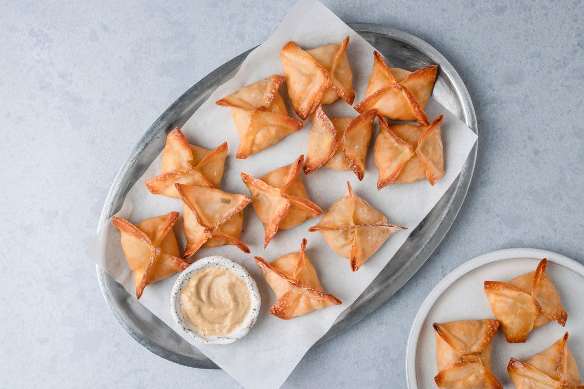 Baked Crab Rangoon is ready and served in a plate with mustard