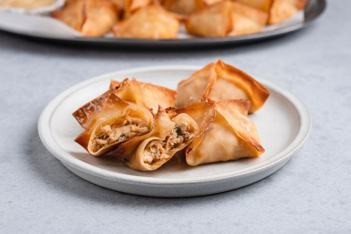 Baked Crab Rangoon is ready and served in a plate with mustard