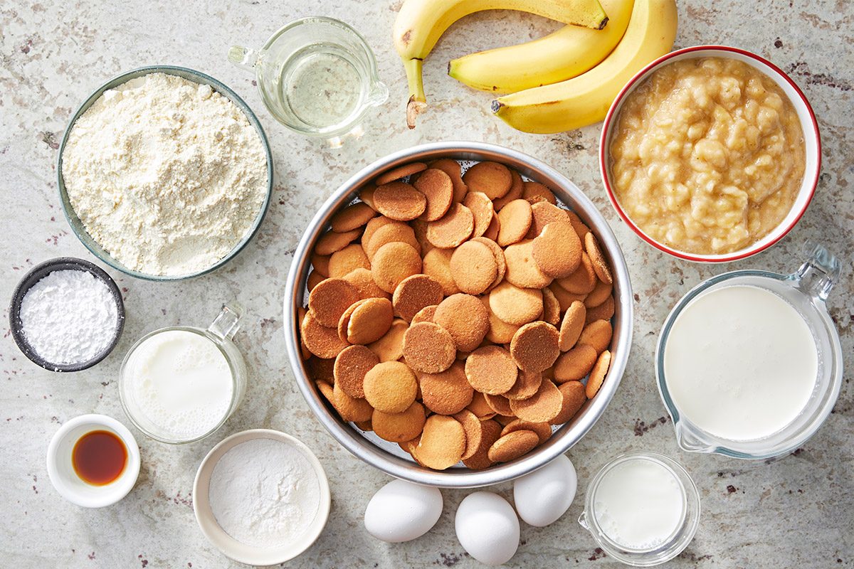 overhead shot of Banana Pudding Cake ingredients placed over white textured background