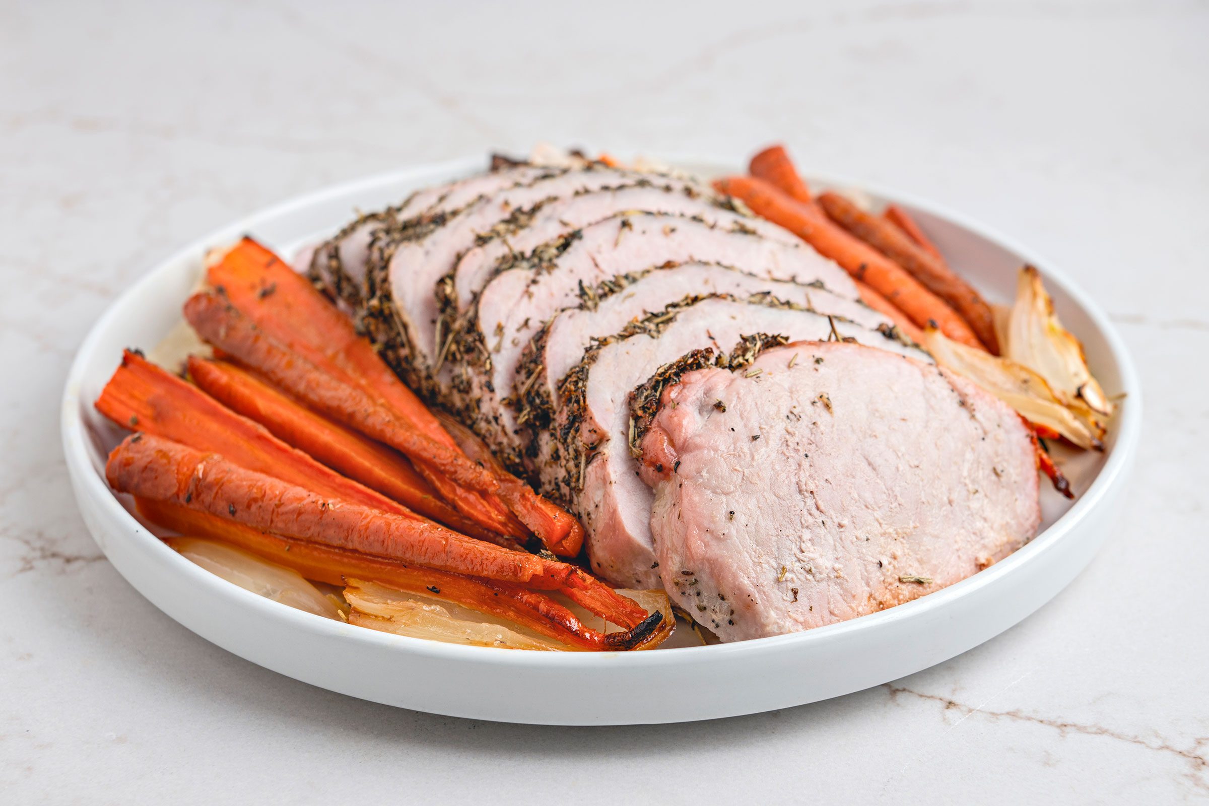 Italian Pork Loin sliced and served on a white plate