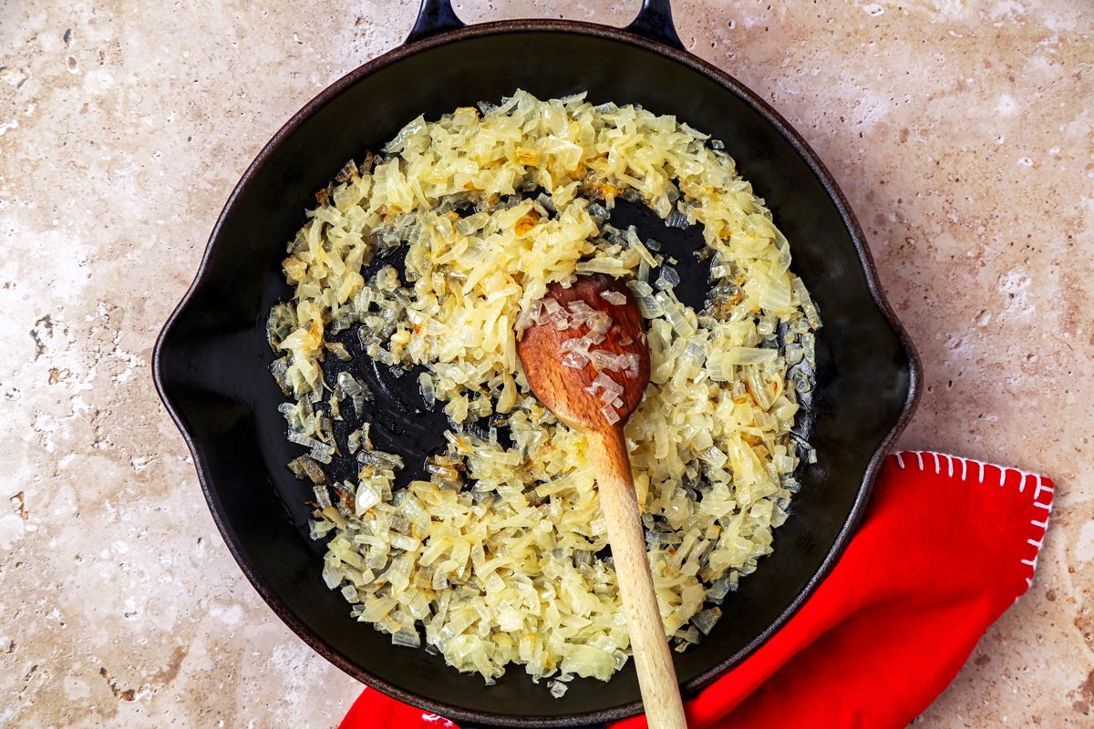 onions being cooked in a large skillet