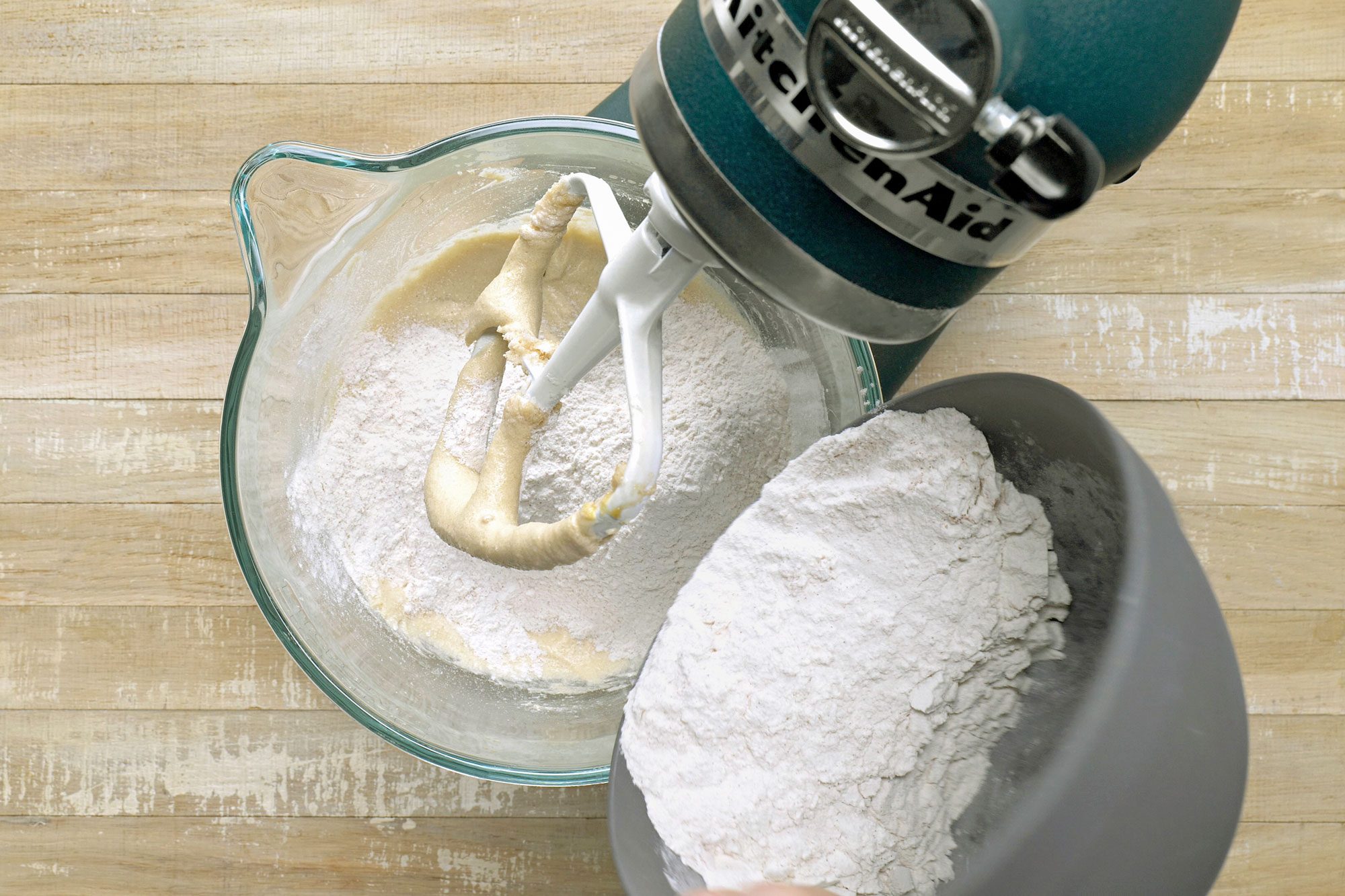 Overhead shot of add to creamed mixture; stirring just until combined; wooden surface;