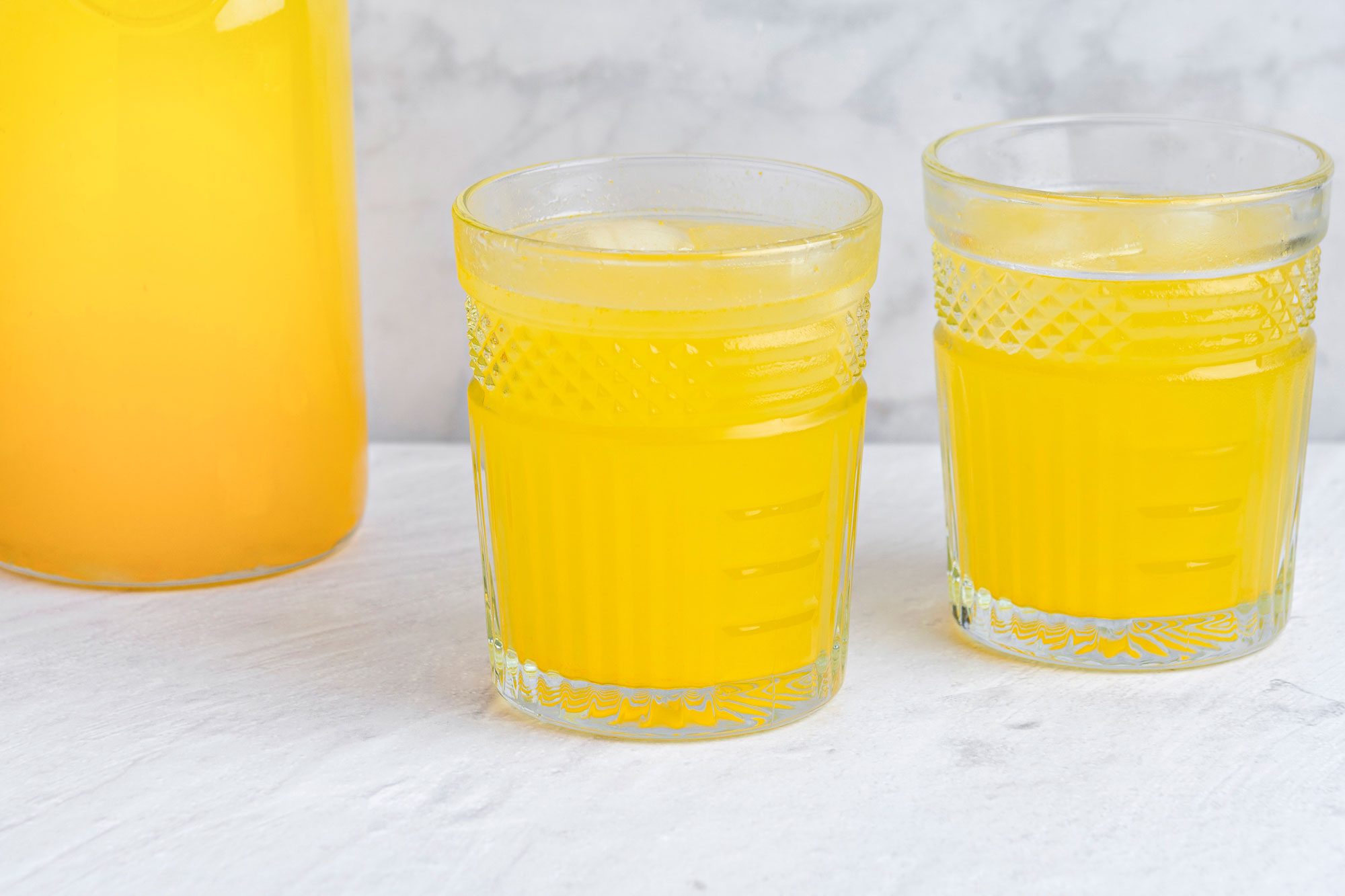 Orange lemonade is ready and served in glasses