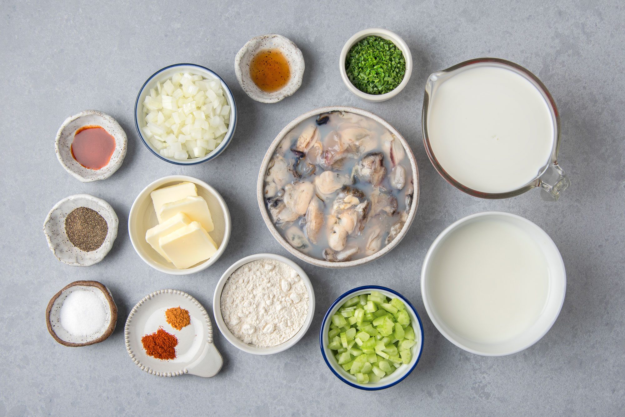 overhead shot of Oyster Stew ingredients placed on light gray background