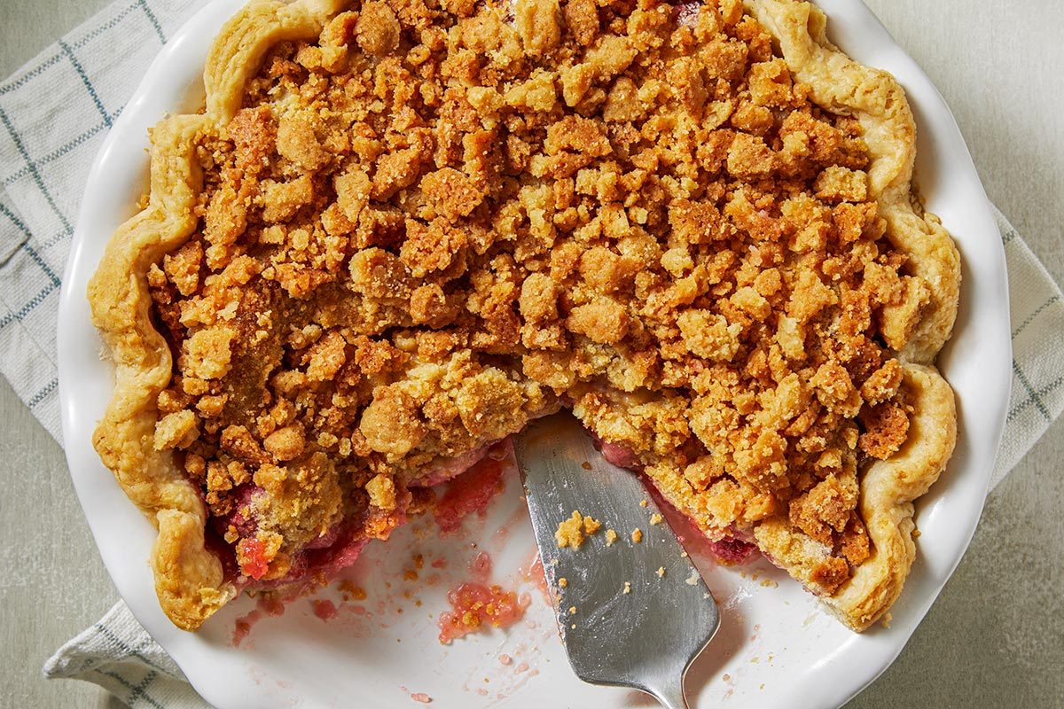 Top view of strawberry crumble pie served on a plate.