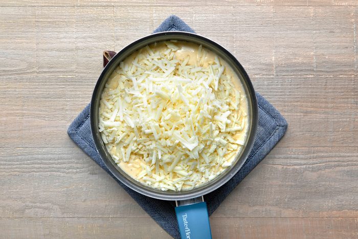 cheddar and manchengo cheese added to cheese sauce mixture