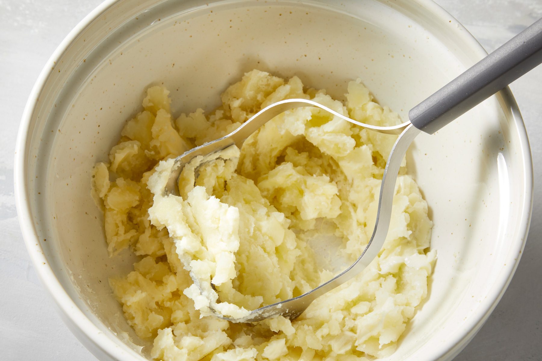 In a large bowl, mash the pulp with butter.
