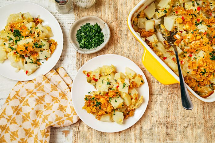 Cottage Potatoes served on small plates with greens on side