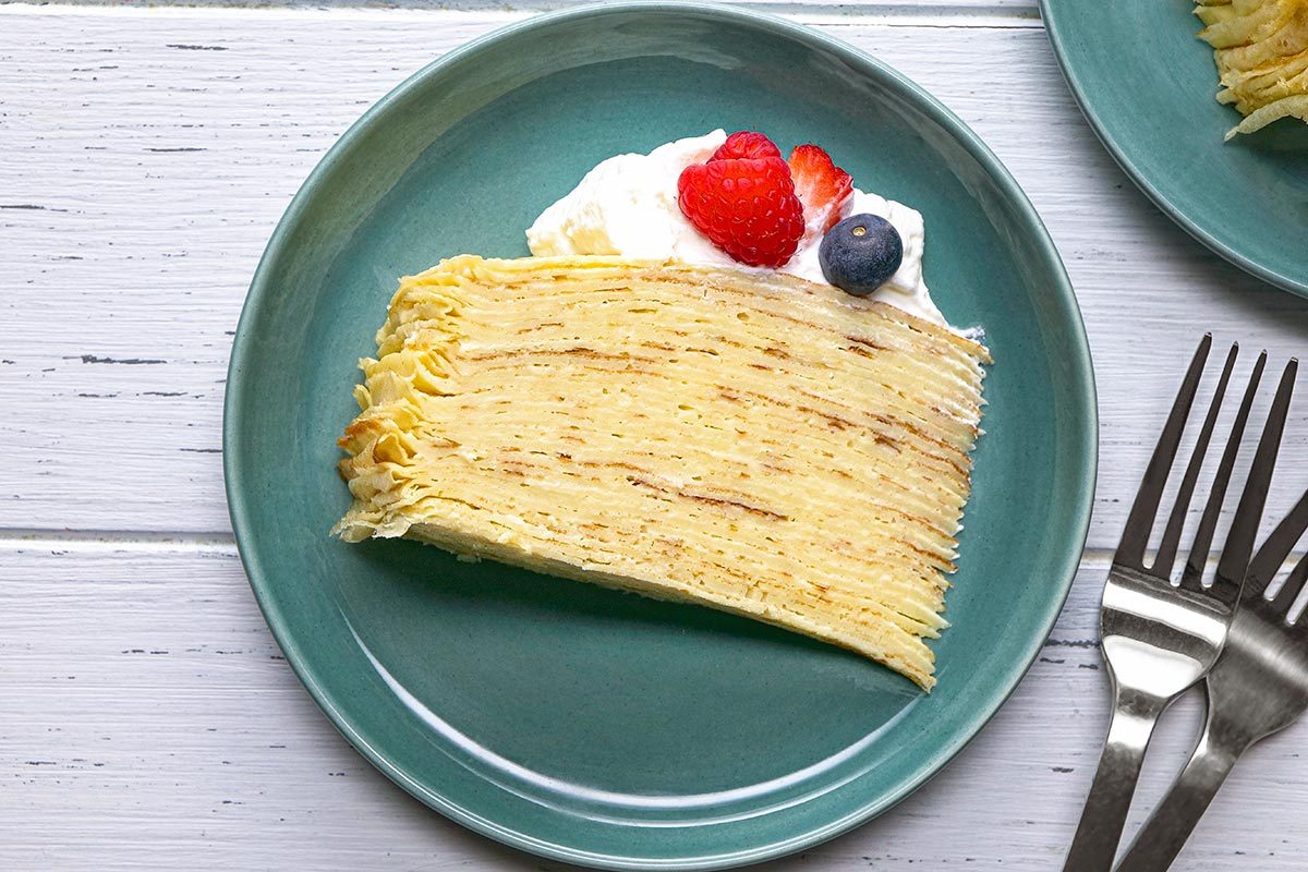 Crepe Cake garnished with berries and cream