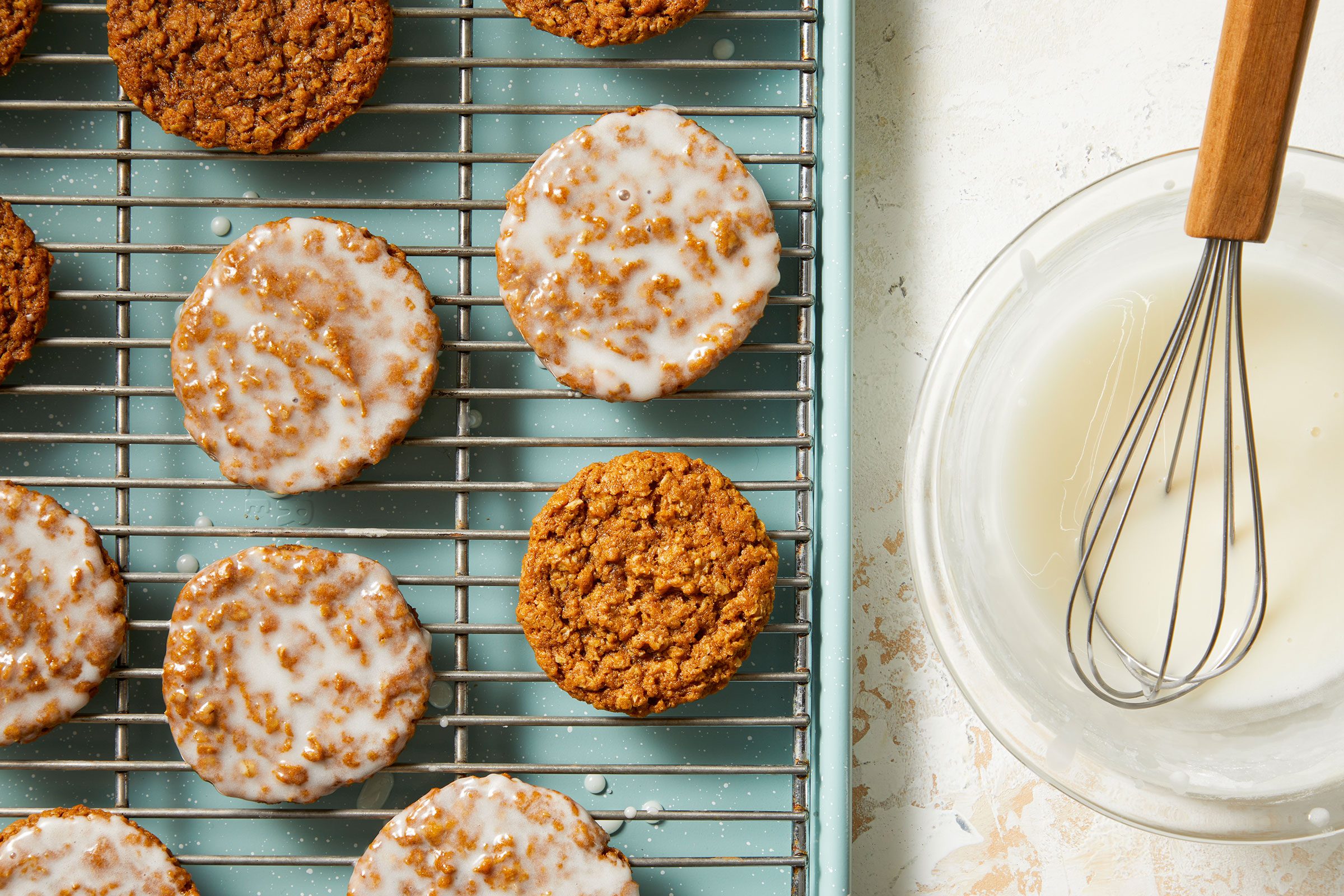 Milk, vanilla extract and confectioners' sugar whisked in a small bowl with cookies glazed with it