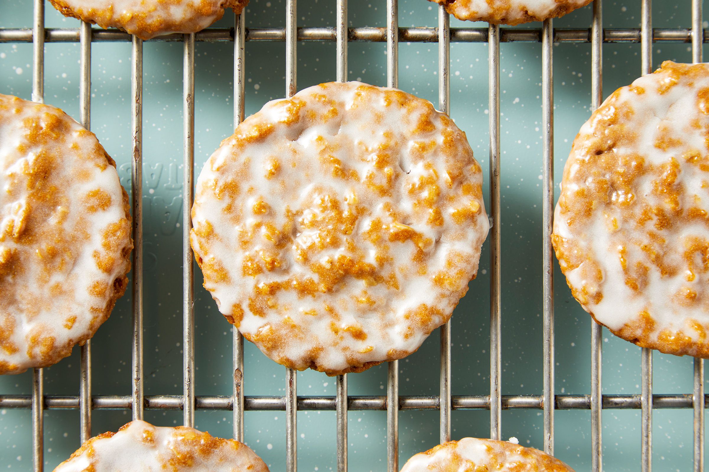 Iced Oatmeal Cookies on a wired rack