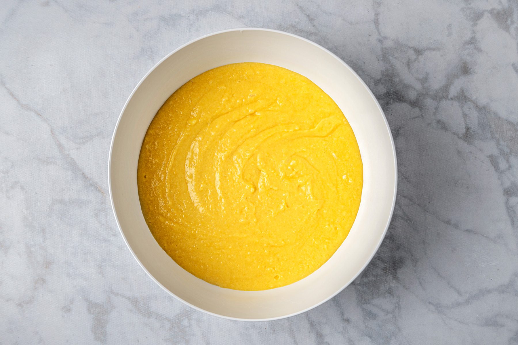 In a large bowl cream sugar and butter until light and fluffy and beat in egg yolks; limoncello; lemon juice; lemon zest and vanilla extract and combine flour; baking powder and salt and add to creamed mixture alternately with milk beating well after each addition