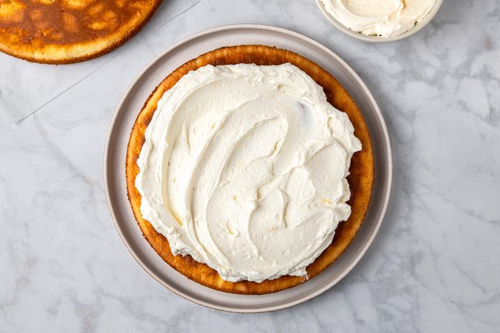 Spread the frosting on top of the cake