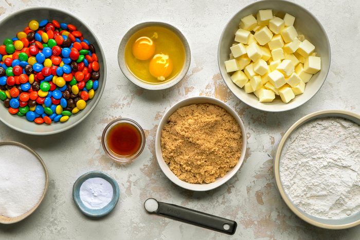 Ingredients for M&M cookies in bowls