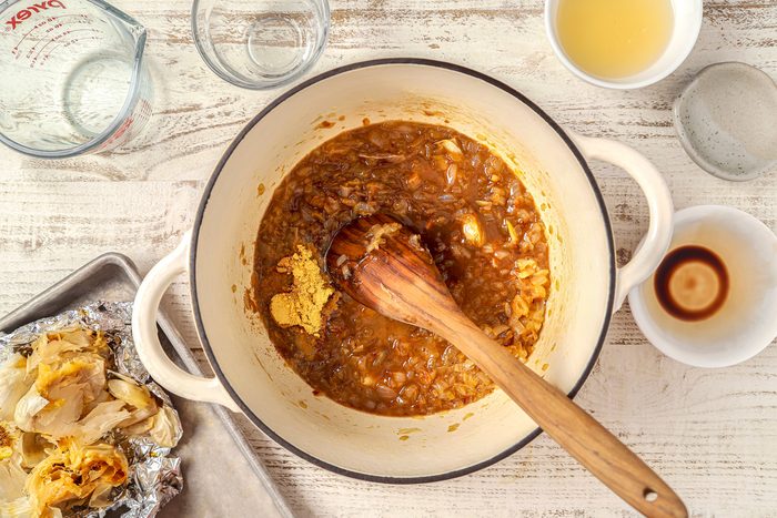 Squeeze softened garlic into Dutch oven and stir in cider vinegar; lemon juice; balsamic vinegar; mustard; salt; pepper; ginger; cloves and sugar