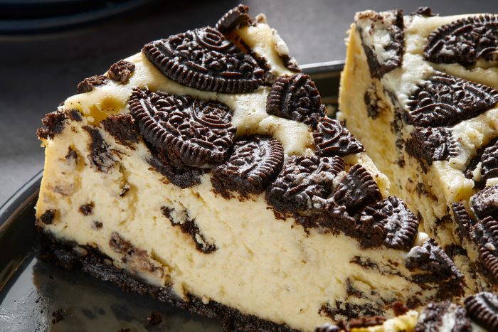 Close up shot of Chocolate Cookie Cheesecake; placed on a large black plate; all set on a dark surface;